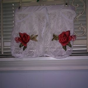 White lace shorts with red flowers on them
